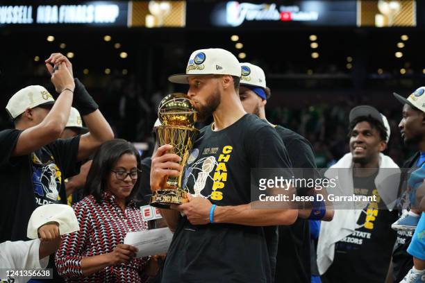 Stephen Curry of the Golden State Warriors celebrates on stage with the Bill Russell Finals MVP Trophy after winning during Game Six of the 2022 NBA...