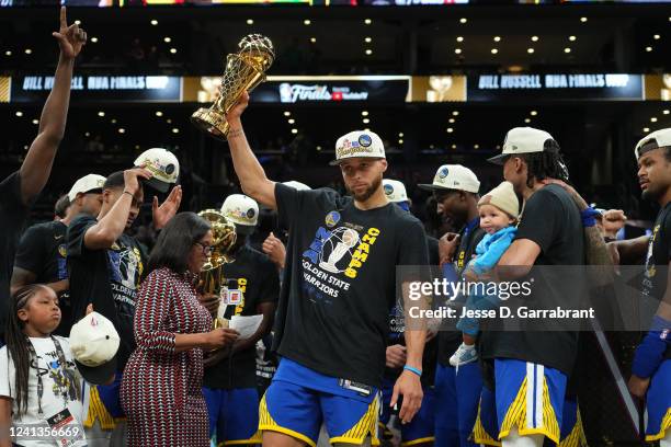 Stephen Curry of the Golden State Warriors celebrates on stage with the Bill Russell Finals MVP Trophy after winning during Game Six of the 2022 NBA...