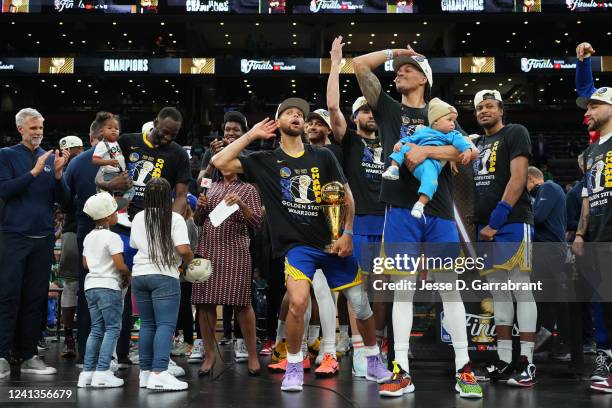 Stephen Curry of the Golden State Warriors celebrates on stage with the Bill Russell Finals MVP Trophy after winning during Game Six of the 2022 NBA...