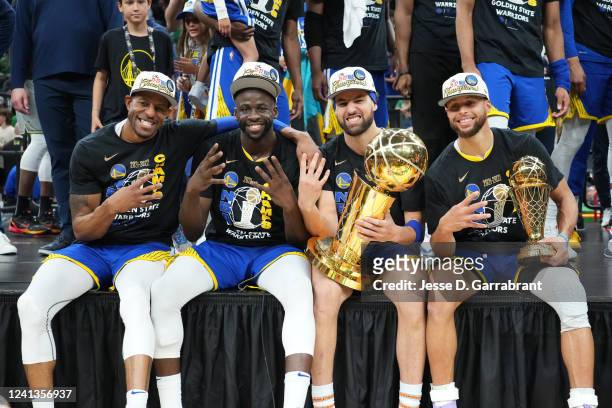 Andre Iguodala, Draymond Green, Klay Thompson and Stephen Curry of the Golden State Warriors celebrate with the Bill Russell Finals MVP Trophy after...