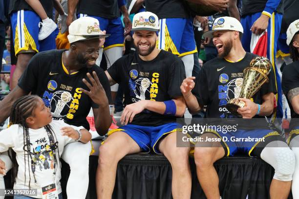 Draymond Green, Klay Thompson and Stephen Curry of the Golden State Warriors celebrate with the Bill Russell Finals MVP Trophy after winning during...