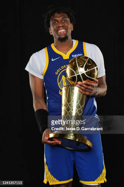 Kevon Looney of the Golden State Warriors poses for a portrait with the Larry OBrien Trophy after winning Game Six of the 2022 NBA Finals against the...
