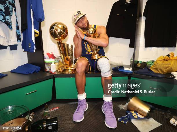 Stephen Curry of the Golden State Warriors celebrates with the Bill Russell NBA Finals MVP Award after Game Six of the 2022 NBA Finals on June 16,...