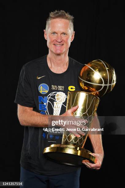 Steve Kerr of the Golden State Warriors poses for a portrait with the Larry OBrien Trophy after winning Game Six of the 2022 NBA Finals against the...