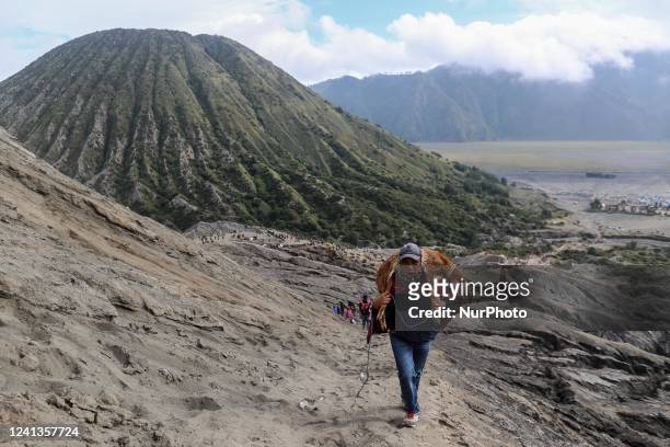 Tenggerese carry goats as offerings during the Yadnya Kasada Festival at the crater of Mount Bromo on June 16, 2022 in Probolinggo, East Java...