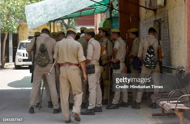 Police personnel take shade to escape the scorching heat, on June 16, 2022 in Noida, India.