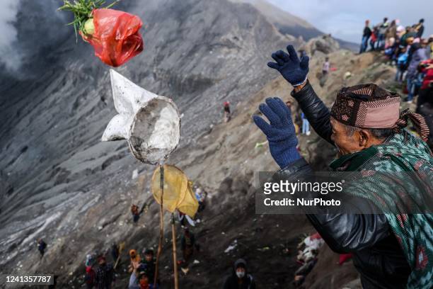 Tenggerese worshipper throw vegetables as offerings during the Yadnya Kasada Festival at the crater of Mount Bromo on June 16, 2022 in Probolinggo,...