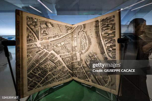 Visitor walks past a manuscript copy of the 1734 Turgot map of Paris, a highly accurate and detailed map of the city as it existed in the 1730s,...