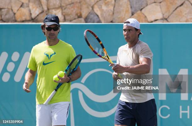 Spanish tennis player Rafael Nadal and his Spanish coach Carlos Moya take part in a training session at Santa Ponsa Country Club in Santa Ponsa, on...