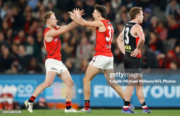 Nick Hind and Nic Martin of the Bombers celebrate during the 2022 AFL Round 14 match between the St Kilda Saints and the Essendon Bombers at Marvel...