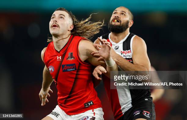 Sam Draper of the Bombers and Paddy Ryder of the Saints compete in a ruck contest during the 2022 AFL Round 14 match between the St Kilda Saints and...