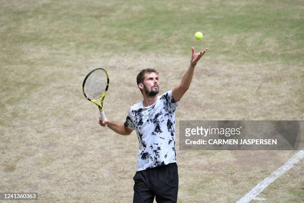 Germany's Oscar Otte serves the ball to Russia's Karen Khachanov during the men's singles match quarter final at the ATP 500 Halle Open tennis...