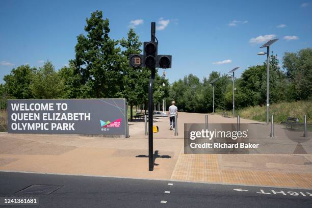 Ten years after the London 2012 Olympics were based here at Stratford, a pedestrian enters The Queen Elizabeth Olympic Park, on 14th June 2022, in...