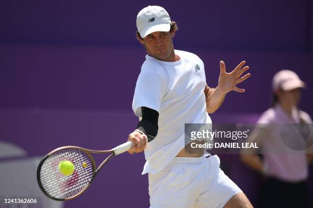 Player Tommy Paul returns to Italy's Matteo Berrettini during their men's singles quarter-final tennis match on Day 5 of the ATP Championships...