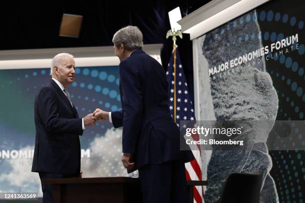 President Joe Biden, left, greets John Kerry, U.S. Special presidential envoy for climate, during the virtual Major Economies Forum on Energy and...
