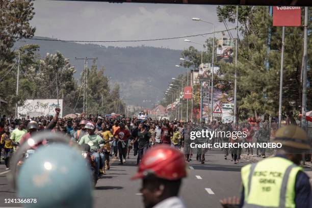 Resident run after the convoy transporting the body of a soldier of the Democratic Republic of Congo from the Rwanda border post of Rubavu on June...