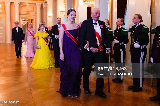 Norway's Princess Ingrid Alexandra accompanies Norway's King Harald V to The Great Hall before a gala dinner for her 18th birthday at the Palace in...