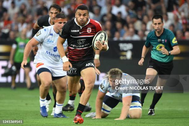Toulouse's French wing Matthis Lebel runs to score a try during the French Top 14 semi-final rugby union match between Castres Olympique and Stade...