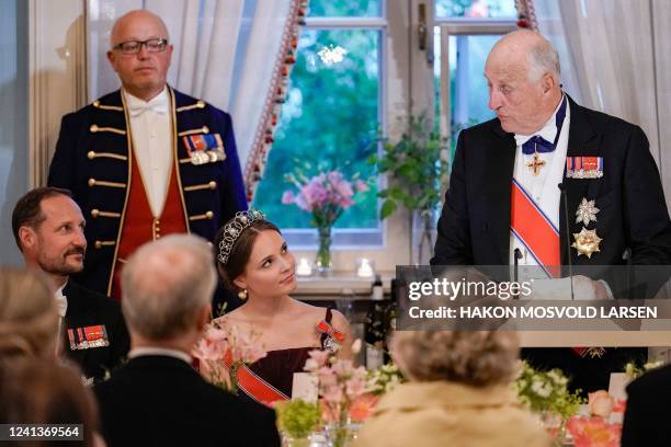 Norway's Princess Ingrid Alexandra and Norway's Crown Prince Haakon listen as Norway's King Harald V delivers a speech during a gala dinner for her...