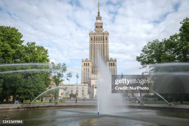 Water fountain is seen spraying water in front of the Palace of Culture and Sciences in a park in Warsaw, Poland on 14 June, 2022.