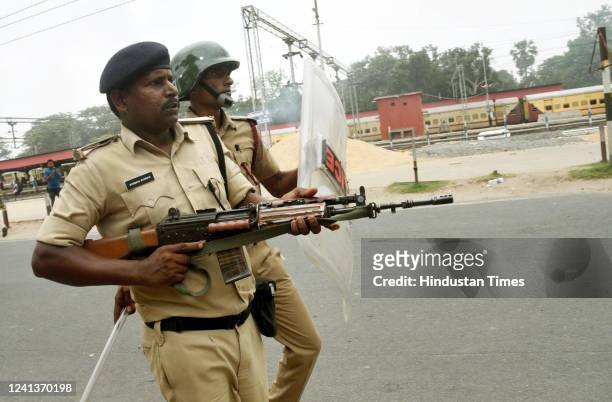 Police personnel try to scare off protesters outside Danapur Railway Station during a protest against the Agnipath army recruitment scheme on June...