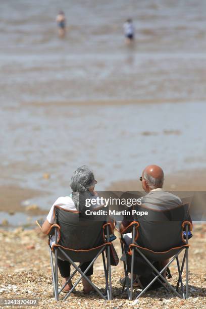 Sunbathers in folding chairs enjoy the sun's rays in the morning on a fairly empty beach on June 17, 2022 in Hunstanton, England. On the warmest day...