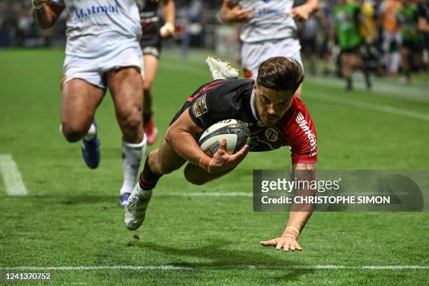 Toulouse's French fly-half Romain Ntamack dives to score a try during the French Top 14 semi-final rugby union match between Castres Olympique and...