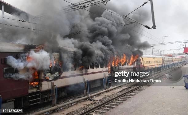 Protester set ablaze Farakka Express train during a protest against the Agnipath army recruitment scheme at Danapur Railway Station on June 17, 2022...