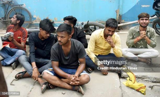 Protester detained during a protest against the Agnipath army recruitment scheme at Danapur Railway Station on June 17, 2022 in Patna, India. The...