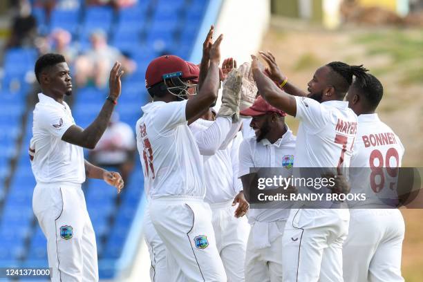 Alzarri Joseph and Kyle Mayers of West Indies celebrate the dismissal of Mehidy Hasan Miraz of Bangladesh during the 2nd day of the 1st Test between...