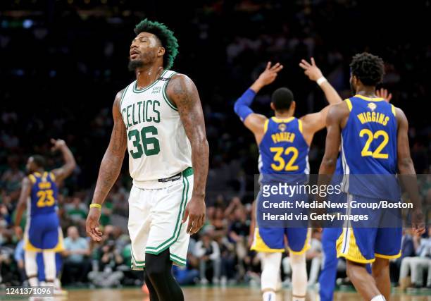 Marcus Smart of the Boston Celtics walks off the court as the Golden State Warriors celebrate during the third quarter of Game 6 of the NBA Finals at...