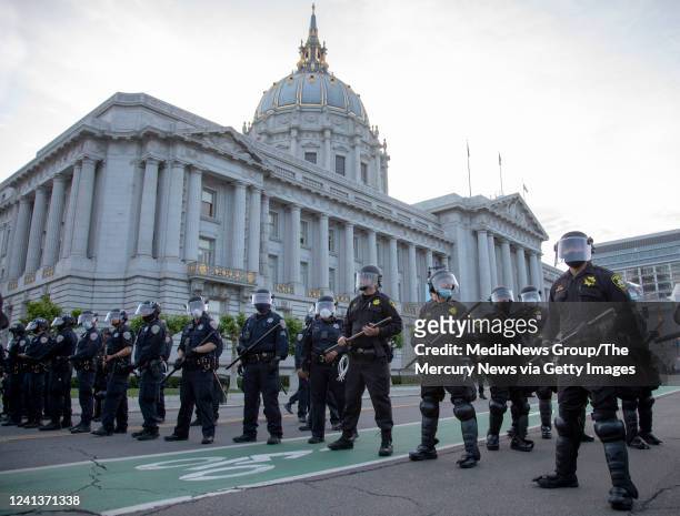 Police clear out a protest in front of San Francisco City Hall after the 8 PM curfew went into effect, Sunday, May 31 the third day of Bay Area...