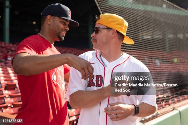 Xander Bogaerts of the Boston Red Sox reacts with former Boston Red Sox infielder Brock Holt before a game between the St. Louis Cardinals and the...