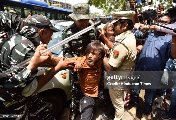 Delhi Police personnel detain members of AISA and CYSS during a protest against the Agnipath recruitment scheme of Indian Army, at ITO, on June 17,...