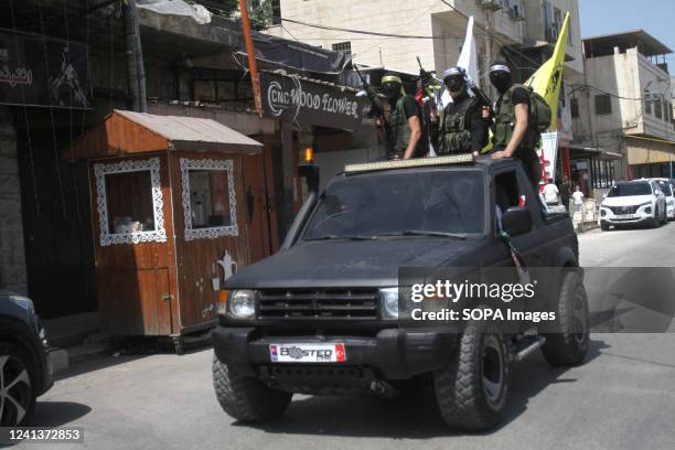 Palestinian gunmen take part in a funeral of three Palestinians who were shot dead by the Israeli army conducting an army operation in the city of...