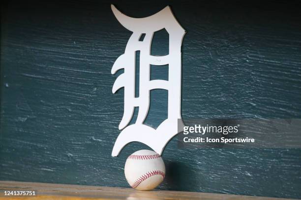 Baseball sits on a shelf under the Detroit logo in the dugout during a regular season Major League Baseball game between the Texas Rangers and the...