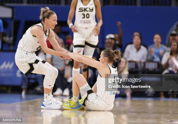 Chicago Sky guard Courtney Vandersloot helps Chicago Sky guard Allie Quigley off the floor after being fouled during a WNBA Commissioners Cup game...