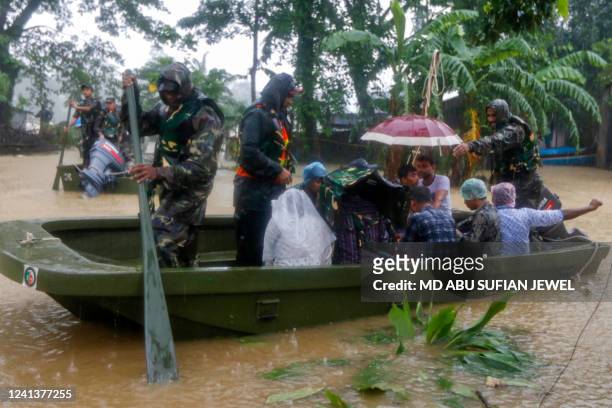 Bangladesh army personnel evacuate affected people from a flooded area following heavy monsoon rainfalls in Sylhet on June 18, 2022. Monsoon storms...