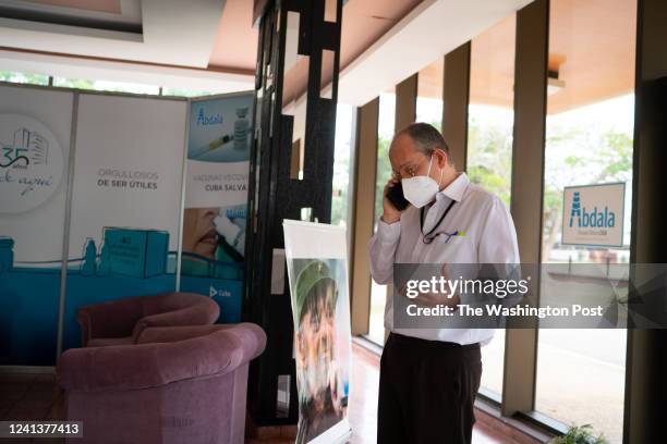 Dr. Gerardo Guillen, Director of Biomedical Research at The Center for Genetic Engineering and Biotechnology in Havana, Cuba talks on the phone in...