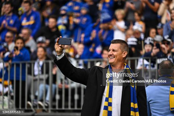 Glen Jakovich takes a selfie during a lap of Honour during the 2022 AFL Round 14 match between the West Coast Eagles and the Geelong Cats at Optus...