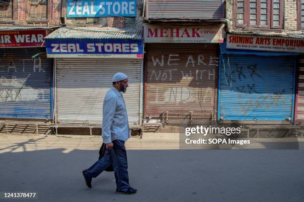 Kashmiri man walks along a deserted street during a shutdown in Srinagar over the derogatory remarks made by two now-sacked India's Hindu nationalist...