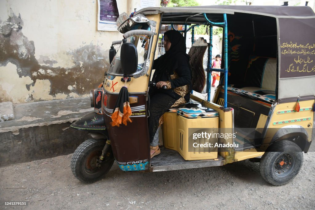 A Rasheed Rickshaw Alisha Abdul Jameel, drives a rickshaw in Karachi on June 15, 2022 ...
