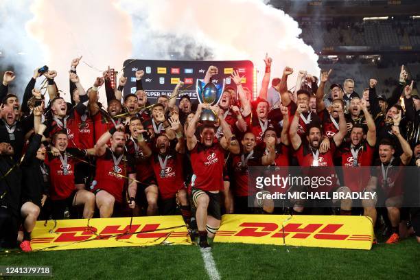 Crusaders' Scott Barrett and teammates celebrate with the trophy after winning the Super Rugby Pacific final match between the New Zealand's Blues...