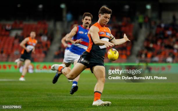 Toby Greene of the Giants kicks the ball during the 2022 AFL Round 14 match between the GWS Giants and the Western Bulldogs at GIANTS Stadium on June...