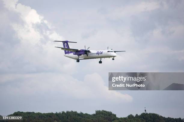 Flybe Bombardier DHC-8-400 turboprop aircraft as seen landing at Amsterdam Schiphol Airport arriving from London Heathrow Airport LHR. The airplane...