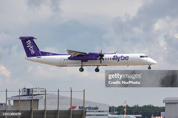 Flybe Bombardier DHC-8-400 turboprop aircraft as seen landing at Amsterdam Schiphol Airport arriving from London Heathrow Airport LHR. The airplane...