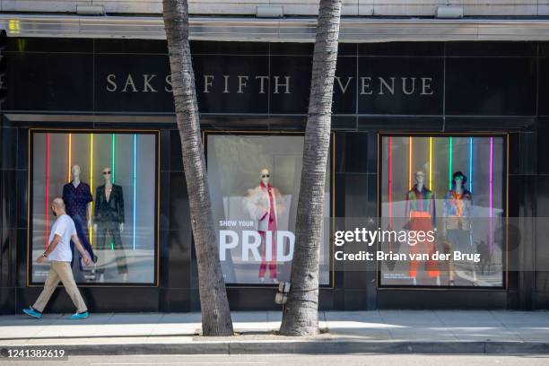 June 16, 2022: A man walks past a window at Saks Fifth Avenue store, one of Beverly Hills most famous department stores, is set to move to make way...