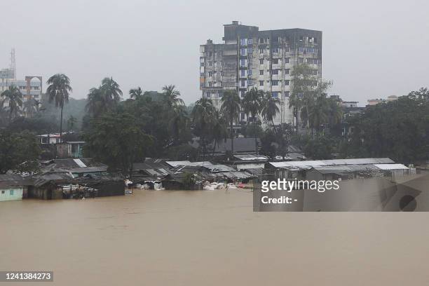 General view shows a flooded residential area following monsoon rainfalls in Sylhet on June 18, 2022. Monsoon storms in Bangladesh and India have...