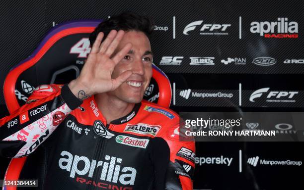 Aprilia Spanish rider Aleix Espargaro waves as he sits in his box during the qualifying session of the MotoGP German motorcycle Grand Prix at the...