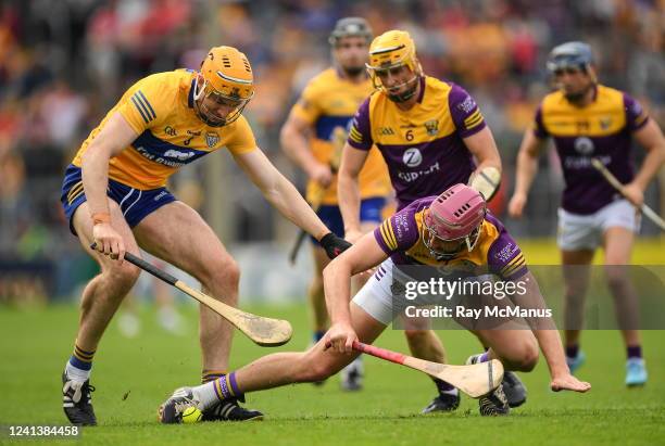 Tipperary , Ireland - 18 June 2022; Paudie Foley of Wexford is tackled by David Fitzgerald of Clare during the GAA Hurling All-Ireland Senior...